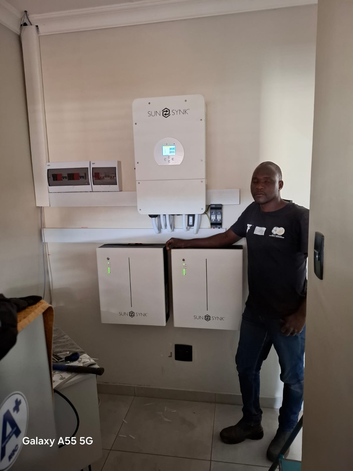 TATT technician beside a complete backup power installation